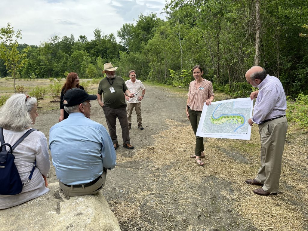 Sen. Welch listens as Erin De Vries from the Vermont River Conservancy shares more about the floodplain restoration project along the Whetstone Brook in Brattleboro